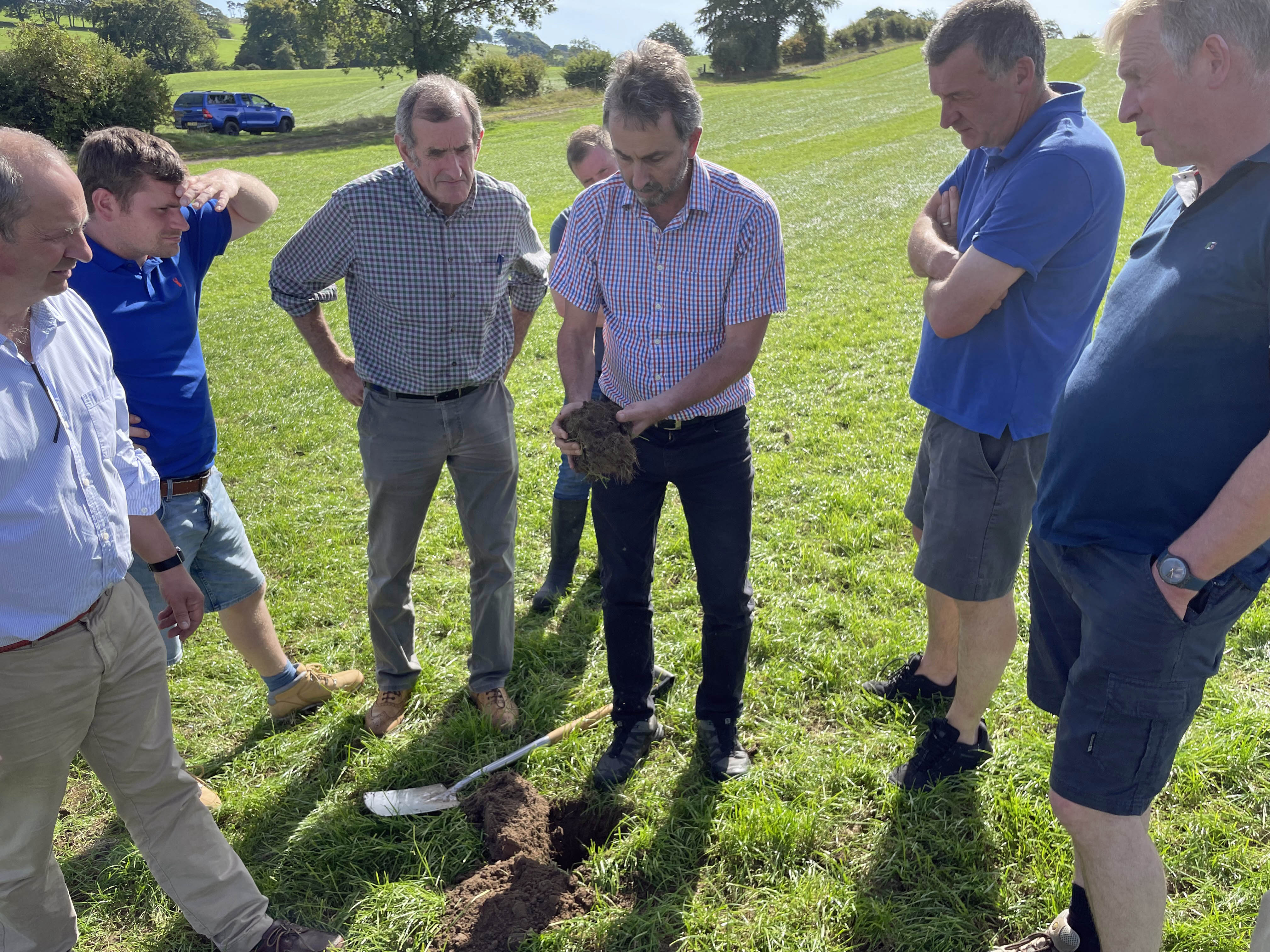 Farmers looking at soil 